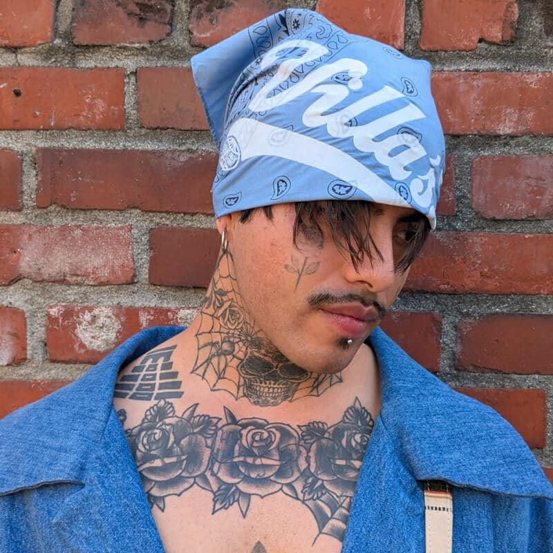 Blue paisley Villa’s bandana worn as a head covering, side view
